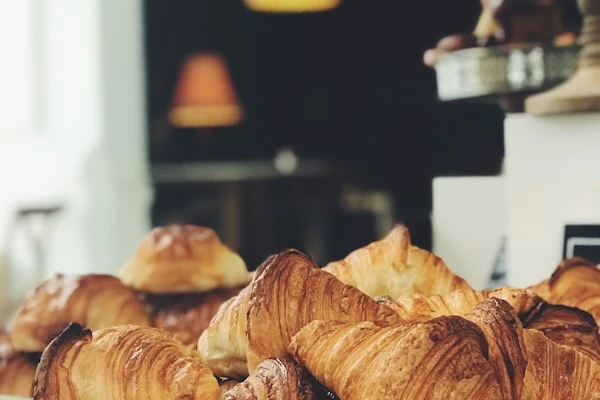 Flaky golden croissants served with freshly brewed artisan flat white coffee